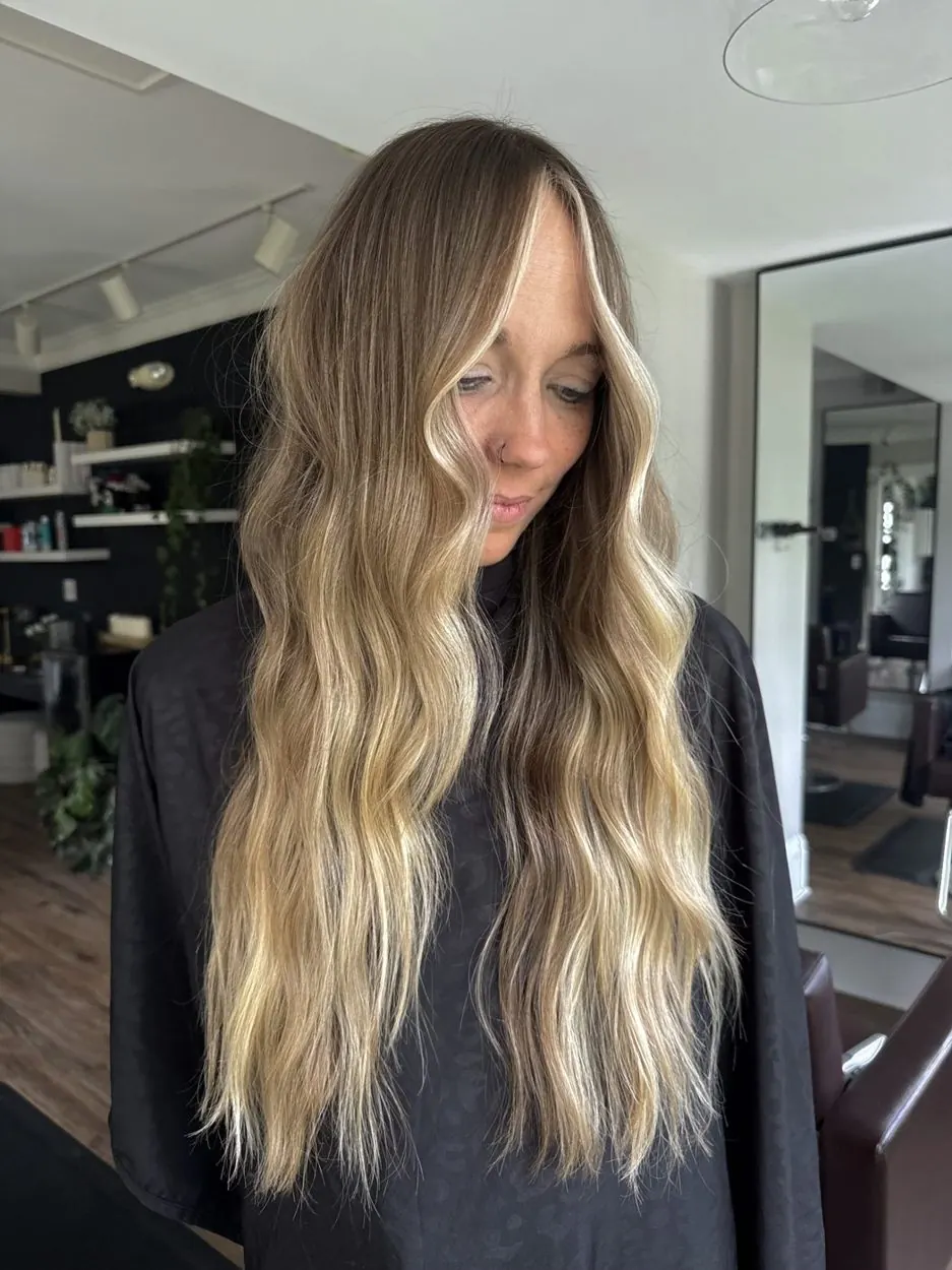 Sun-kissed blonde balayage with beach waves by hairxlaina
